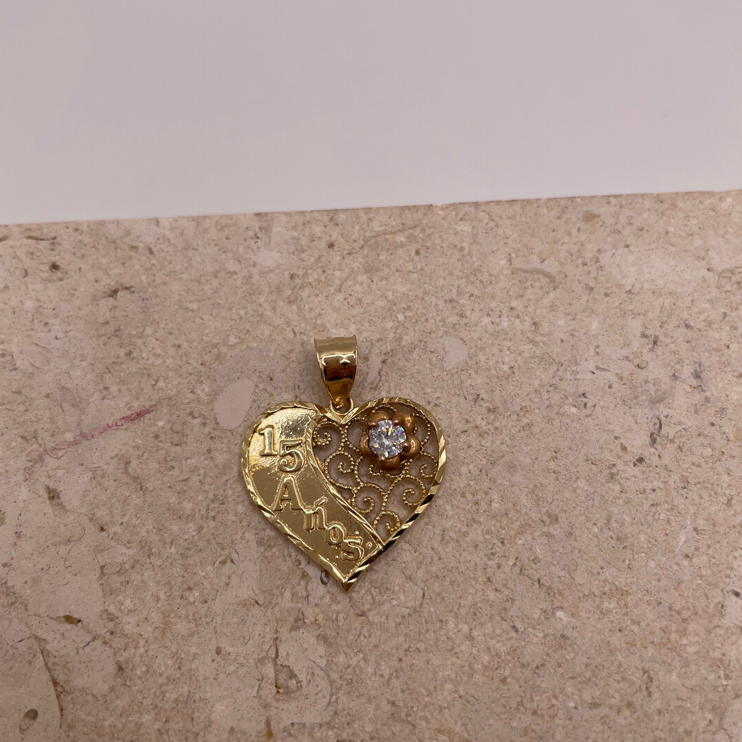 Close-up of 14k Gold '15' Quinceañera pendant with rose gold flower and CZ detail