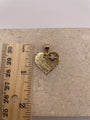 Ruler next to 14k Gold Quinceañera pendant showing 1-inch size.