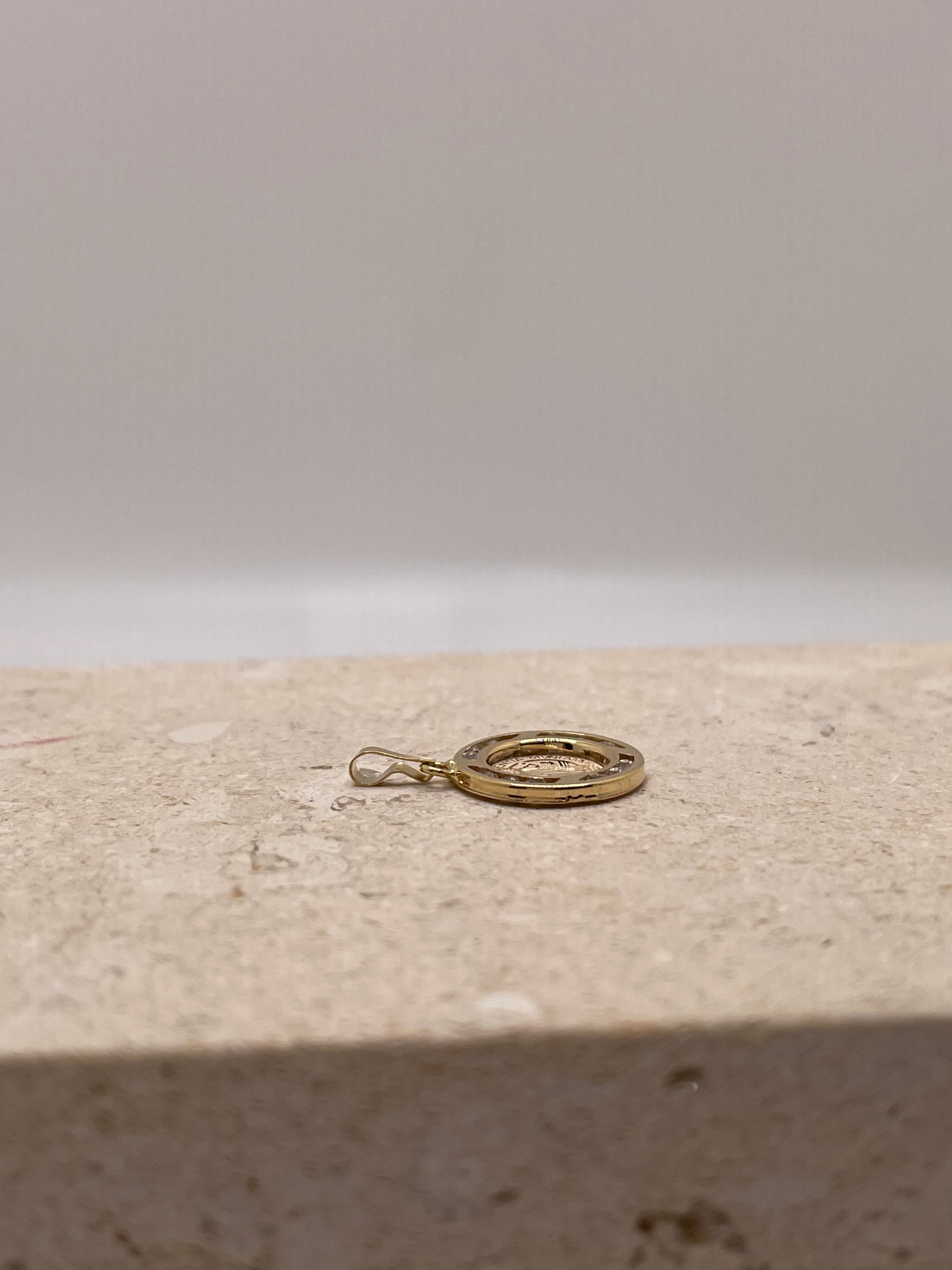 A side view of the pendant showing the thickness and structure of the pendant, as well as the bail, providing insight into how the pendant will hang when worn