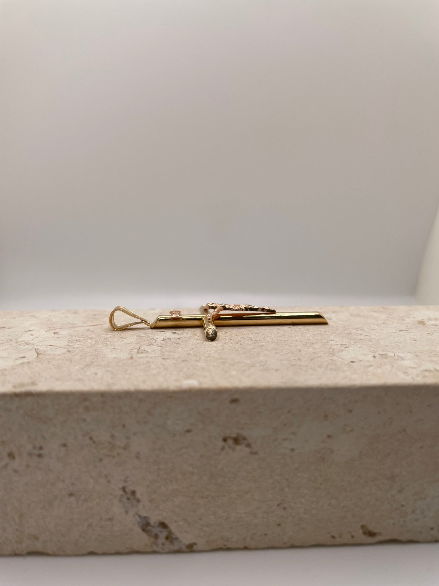 Side view of 14k Gold Tube Cross Crucifix showing fixed bail.