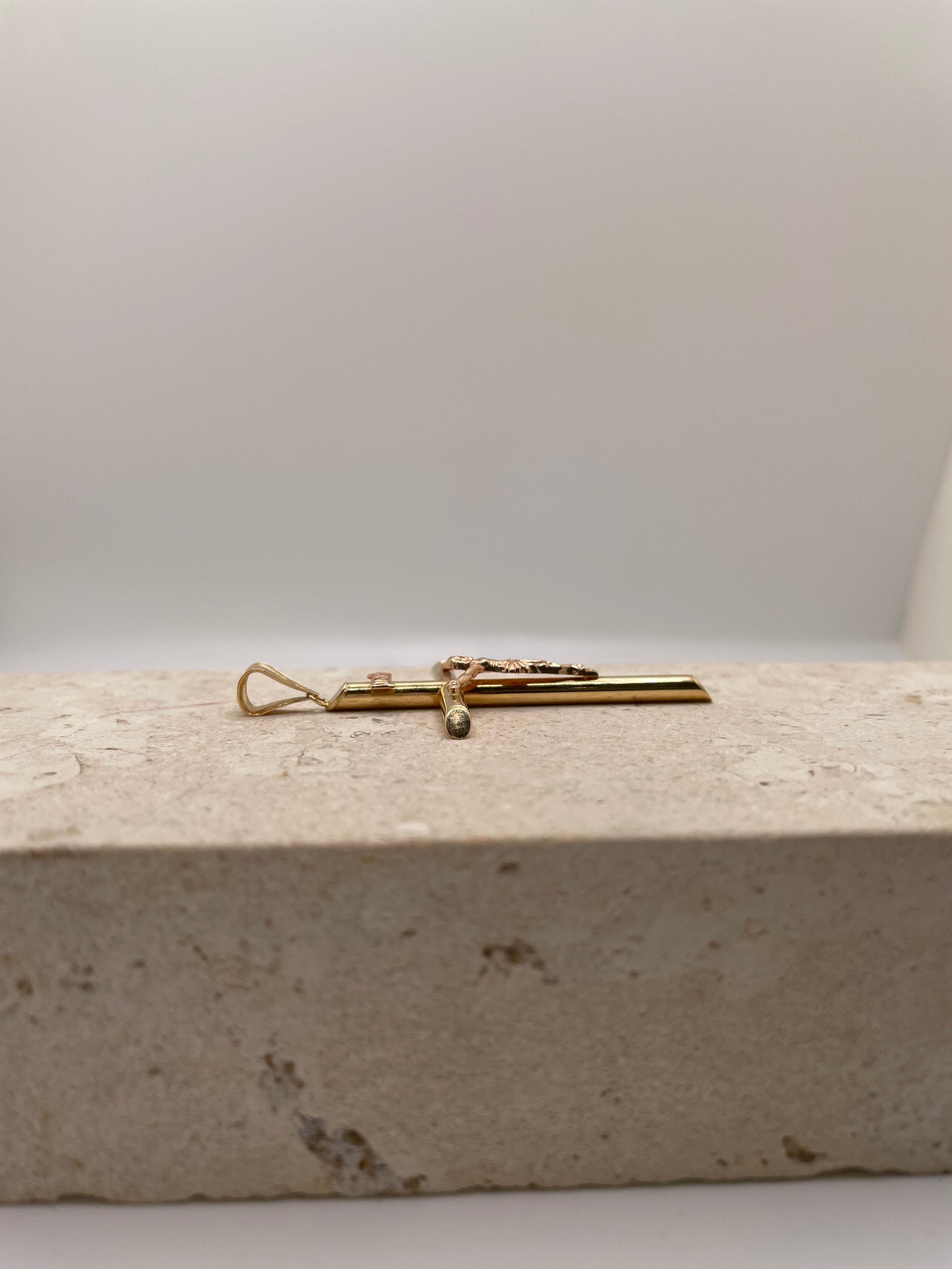 Side view of 14k Gold Tube Cross Crucifix showing fixed bail.