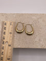 An image showing the earrings next to a ruler, clearly indicating the size of 25mm in height and 20mm in width for a precise visual reference